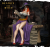 Beatrix z serii Legendary Heroes – czarodziejka w stroju wiedźmy, z księgą zaklęć i purpurowym kapeluszem. Idealna do gier RPG, dioram fantasy i kolekcji. Styl halloweenowy, aura magii, dynamiczna poza.